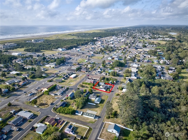 birds eye view of property with a beach view and a water view