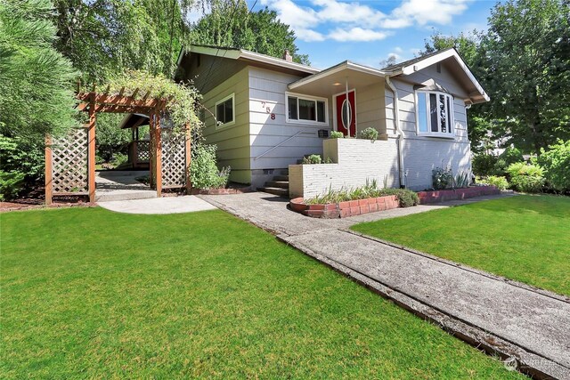 single story home with a pergola, a front lawn, and a patio area