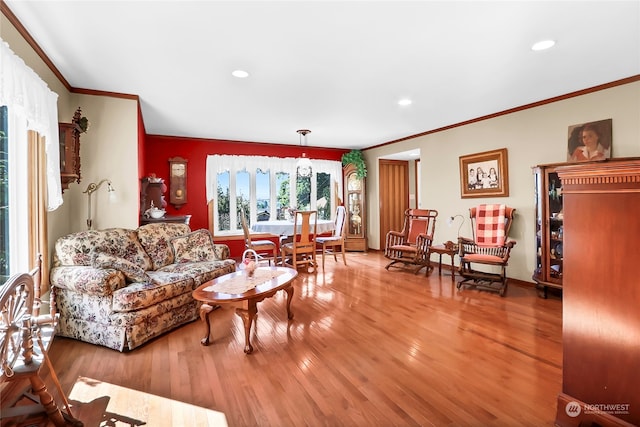 living room with hardwood / wood-style flooring and ornamental molding