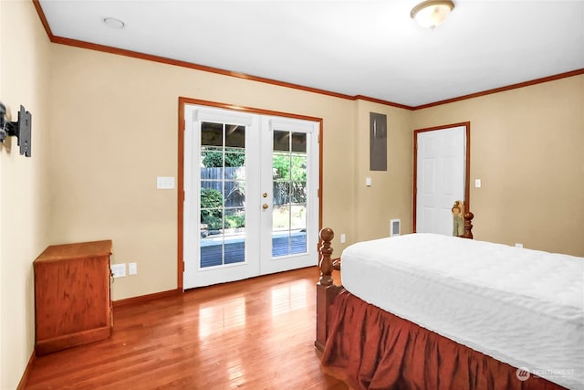 bedroom featuring wood-type flooring, crown molding, french doors, and access to exterior