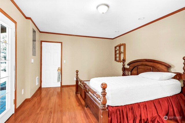 bedroom featuring light hardwood / wood-style flooring and crown molding