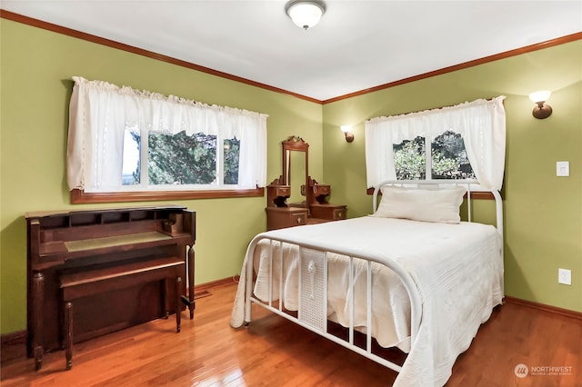 bedroom featuring ornamental molding and hardwood / wood-style floors