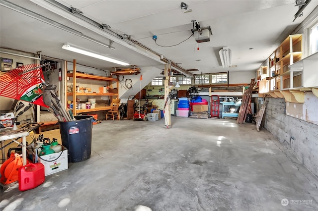 garage with a garage door opener and a workshop area