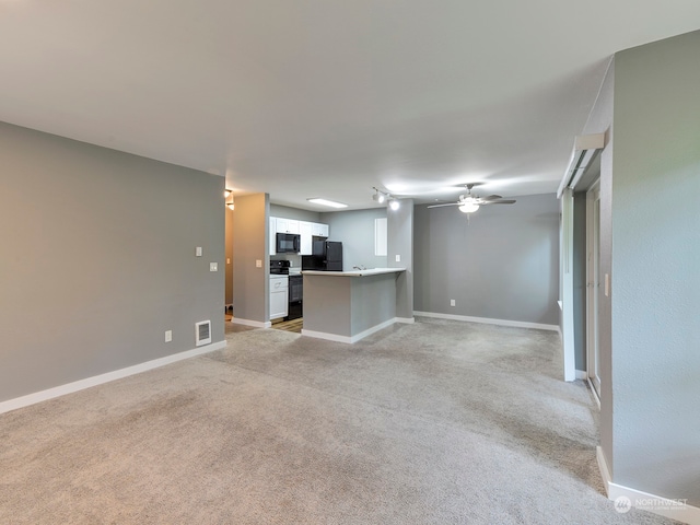 unfurnished living room with ceiling fan and light colored carpet