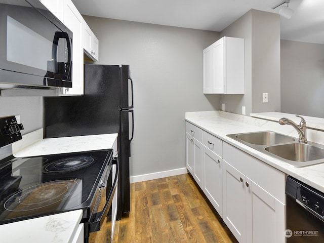 kitchen featuring white cabinets, sink, black appliances, dark hardwood / wood-style floors, and light stone countertops