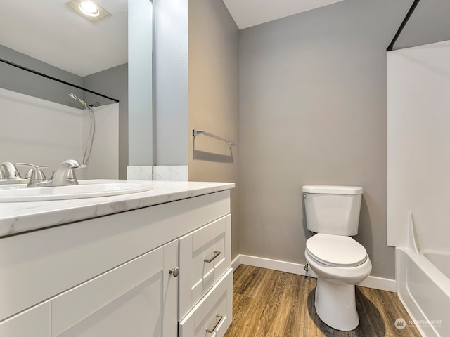 full bathroom with wood-type flooring, vanity, shower / bath combination, and toilet