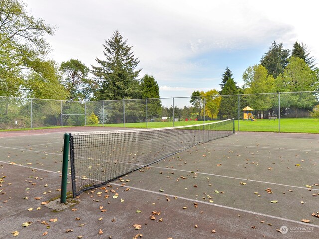 view of property's community with tennis court