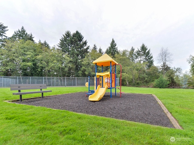 view of jungle gym featuring a lawn