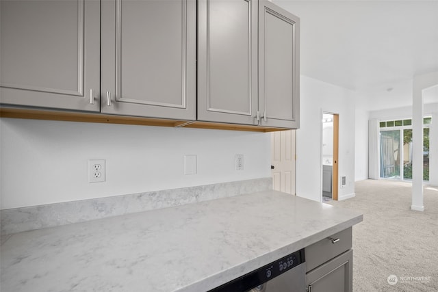 kitchen featuring light carpet and gray cabinetry