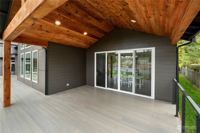 exterior space with wooden ceiling, wooden walls, light hardwood / wood-style floors, and vaulted ceiling