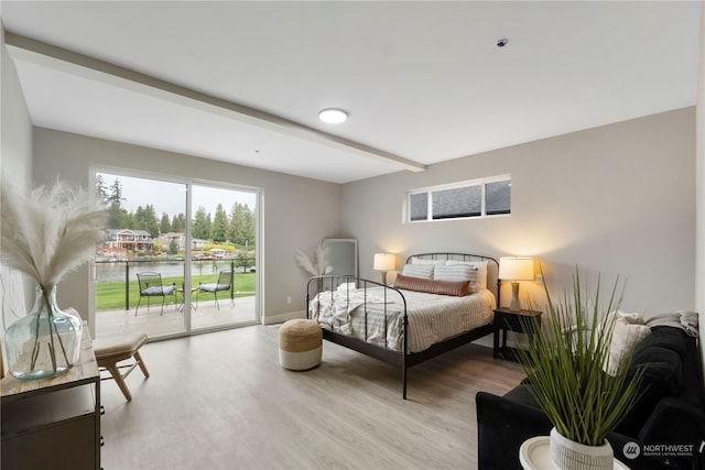 bedroom featuring light hardwood / wood-style floors and access to exterior