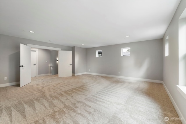 unfurnished room with light carpet