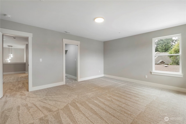 unfurnished room with light colored carpet