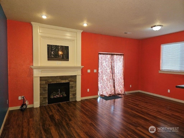 unfurnished living room featuring a textured ceiling, dark hardwood / wood-style flooring, and a fireplace