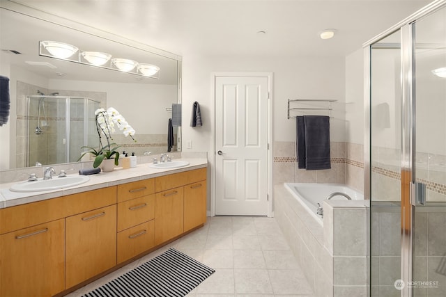 bathroom featuring vanity, separate shower and tub, and tile patterned floors