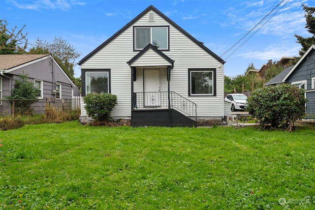 rear view of property with a yard