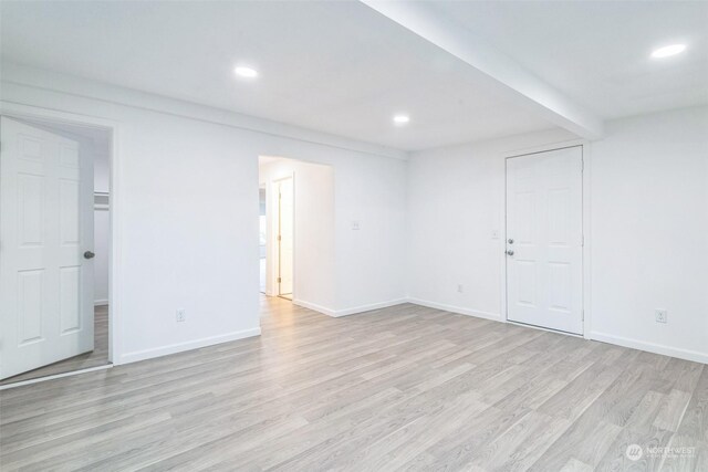 empty room with light hardwood / wood-style flooring