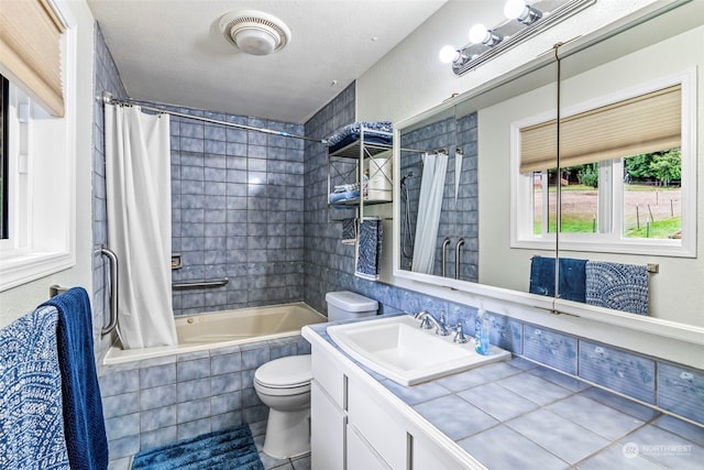 full bathroom featuring a textured ceiling, tile patterned floors, shower / bathtub combination with curtain, toilet, and vanity