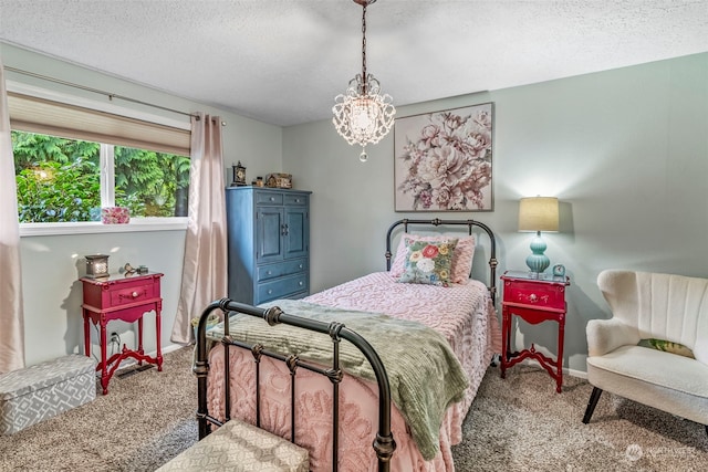 bedroom with a textured ceiling and carpet flooring