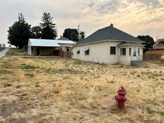 view of back house at dusk