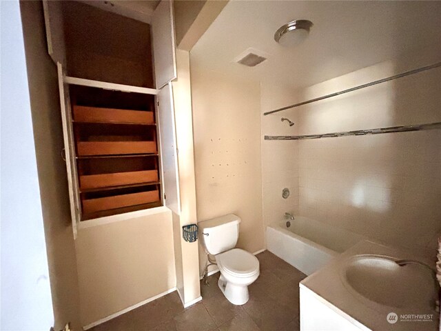 full bathroom with tile patterned flooring, vanity, toilet, and tiled shower / bath combo