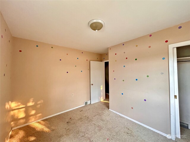 unfurnished bedroom with a closet and carpet