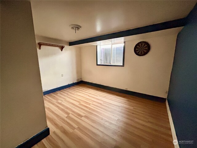 unfurnished room with wood-type flooring