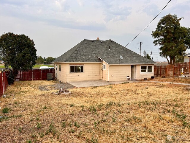 back of property with cooling unit and a patio