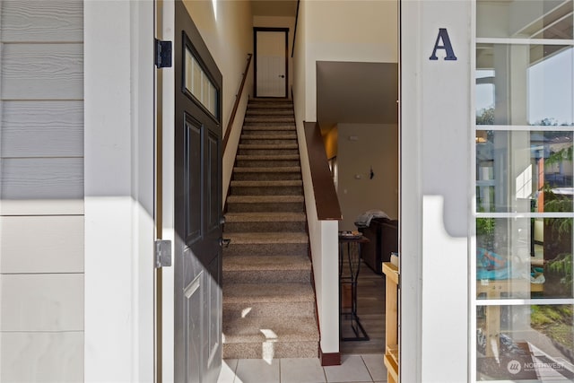 stairway featuring tile patterned floors