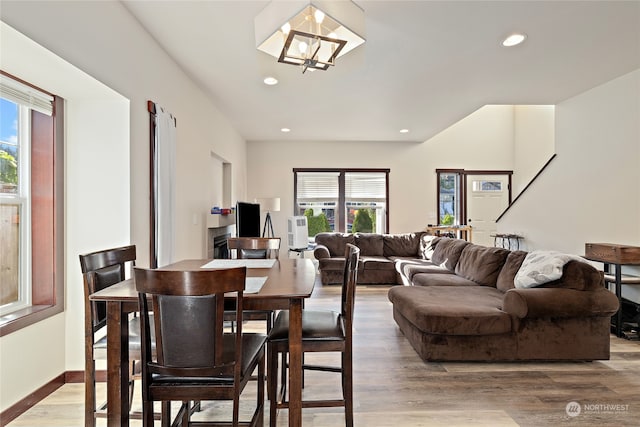 dining space featuring wood-type flooring and an inviting chandelier