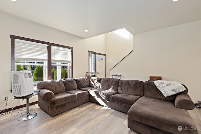 living room with cooling unit and light hardwood / wood-style floors