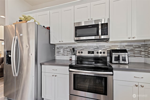 kitchen featuring appliances with stainless steel finishes, wood-type flooring, and white cabinetry