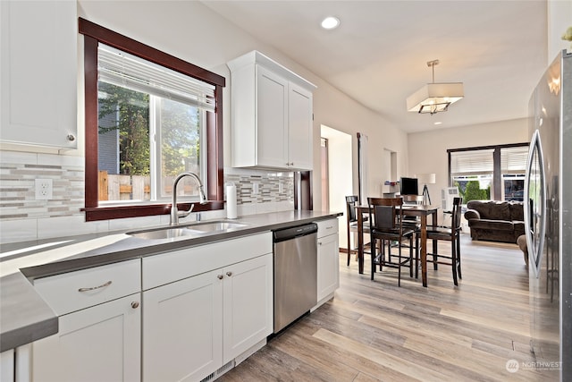 kitchen featuring light hardwood / wood-style floors, stainless steel appliances, plenty of natural light, and sink