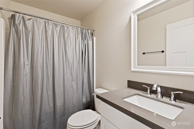 bathroom with a shower with shower curtain, vanity, and toilet