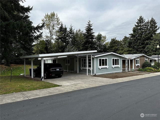 view of front of home with a front lawn and a carport