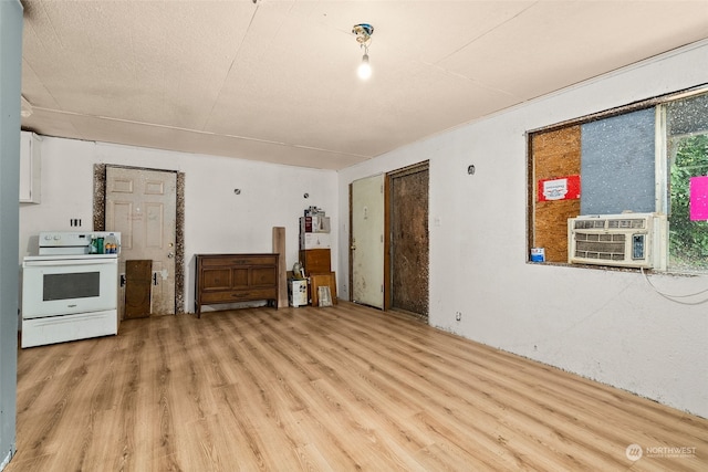 unfurnished living room featuring a textured ceiling, cooling unit, and light hardwood / wood-style floors