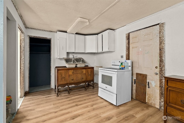 kitchen featuring a textured ceiling, electric range, sink, white cabinetry, and light hardwood / wood-style flooring