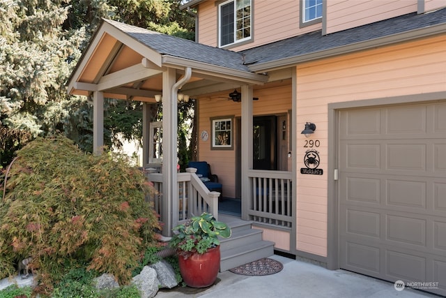 entrance to property featuring covered porch and a garage