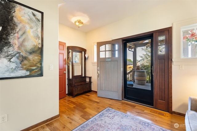 entryway with a healthy amount of sunlight and light hardwood / wood-style floors