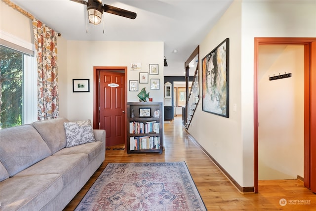 living room featuring light wood-type flooring and ceiling fan