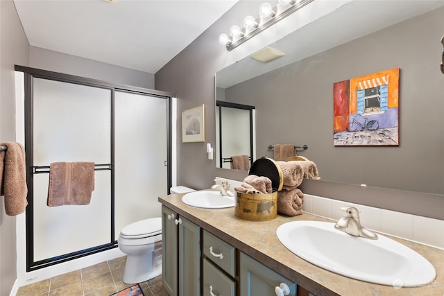 bathroom featuring a shower with shower door, tile patterned flooring, toilet, and vanity