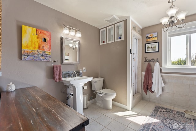 bathroom with a notable chandelier, toilet, and tile patterned floors