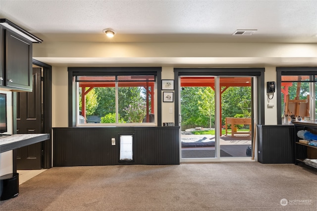 interior space featuring a textured ceiling and carpet