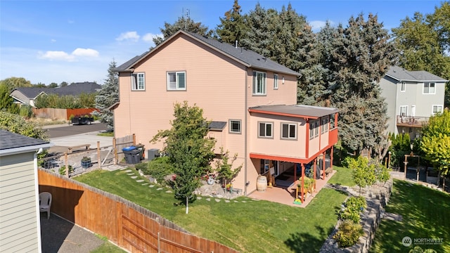 back of property featuring a yard and a patio area