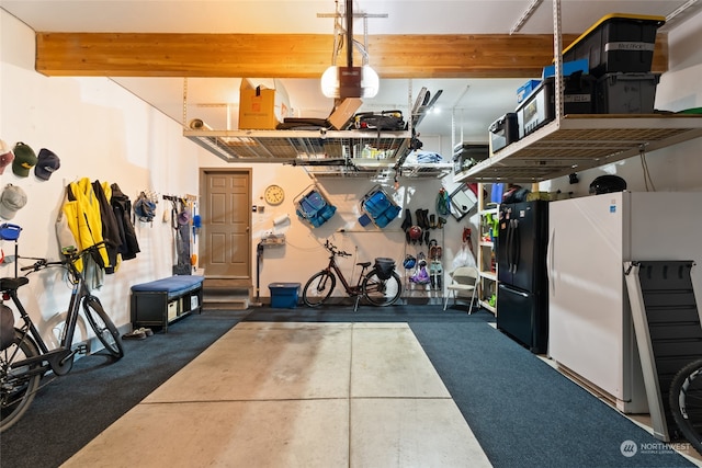 garage featuring white refrigerator and black refrigerator