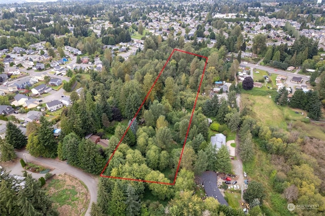 bird's eye view with a wooded view and a residential view