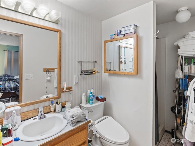 bathroom with tile patterned floors, a shower with curtain, vanity, and toilet