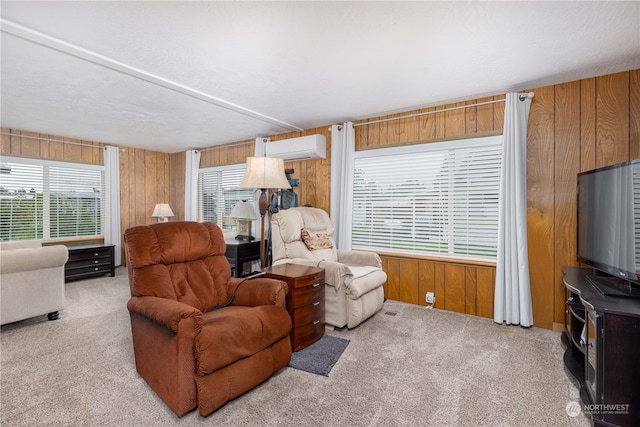 carpeted living room with wooden walls, a wall mounted air conditioner, and a textured ceiling