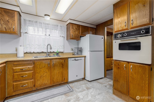 kitchen featuring white appliances and sink