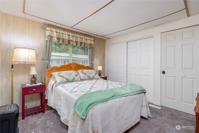 bedroom featuring wood walls and carpet